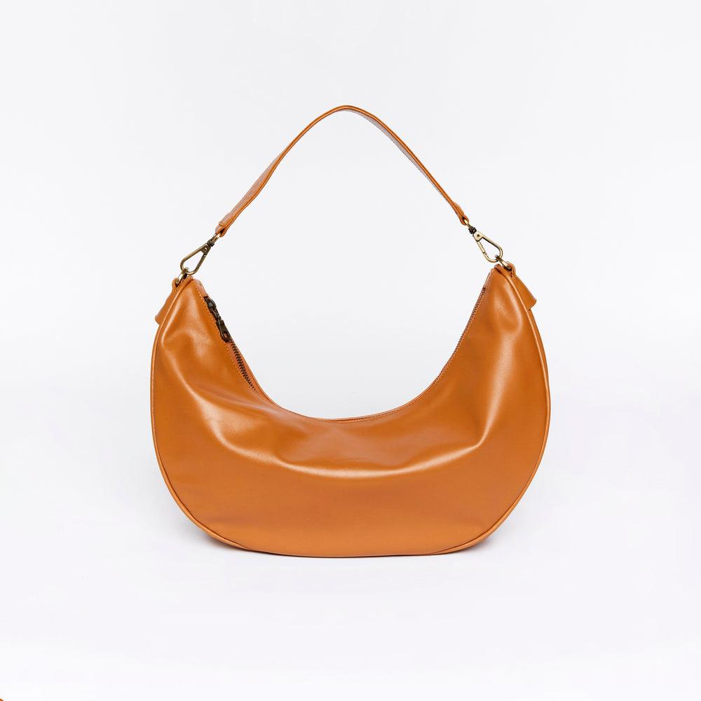 Caramel brown slouchy hobo bag with curved shape