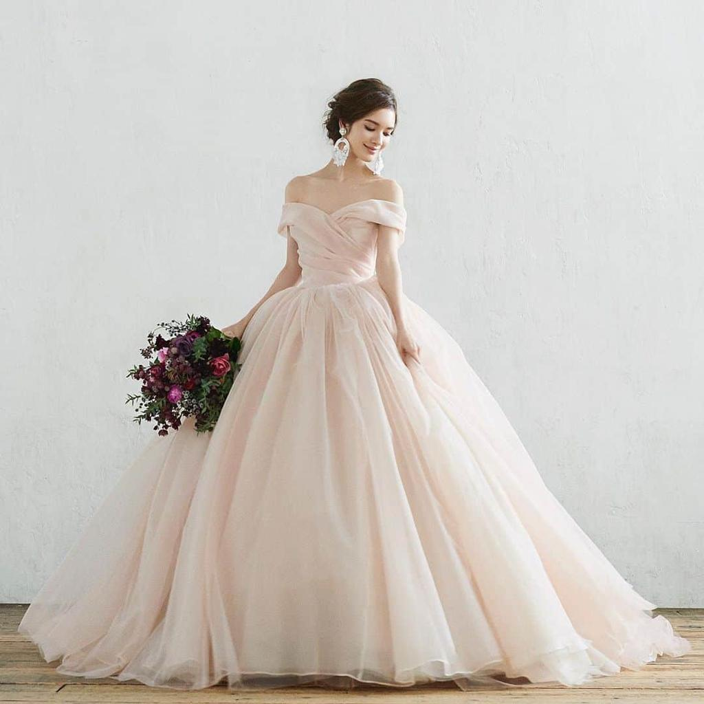 Pink ball gown wedding dress with fitted bodice and full skirt