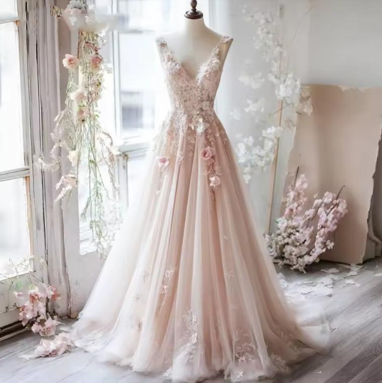 Blush pink A-line wedding dress with floral appliques and tulle skirt